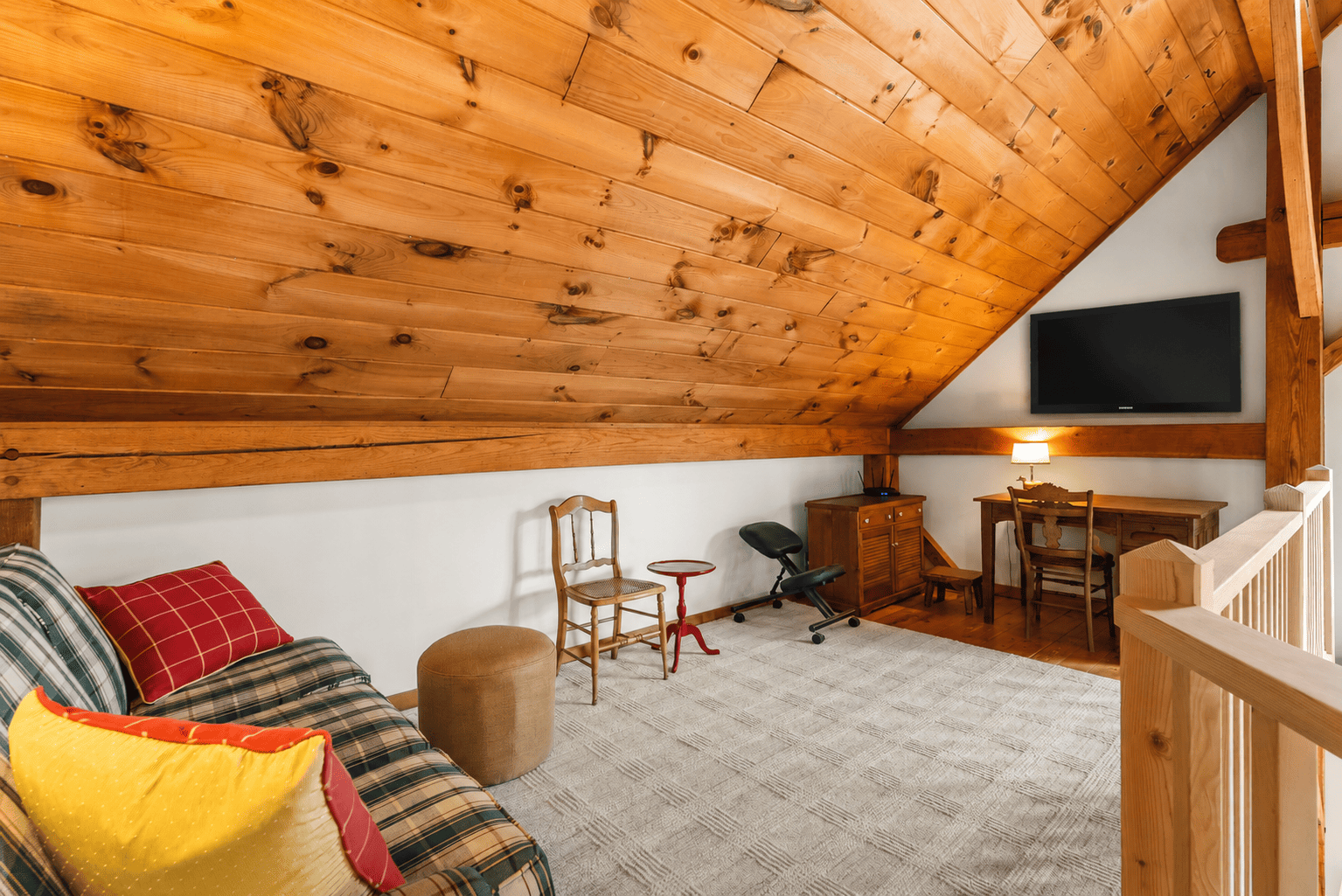 The TV area in the upper floor with comfortable seating.