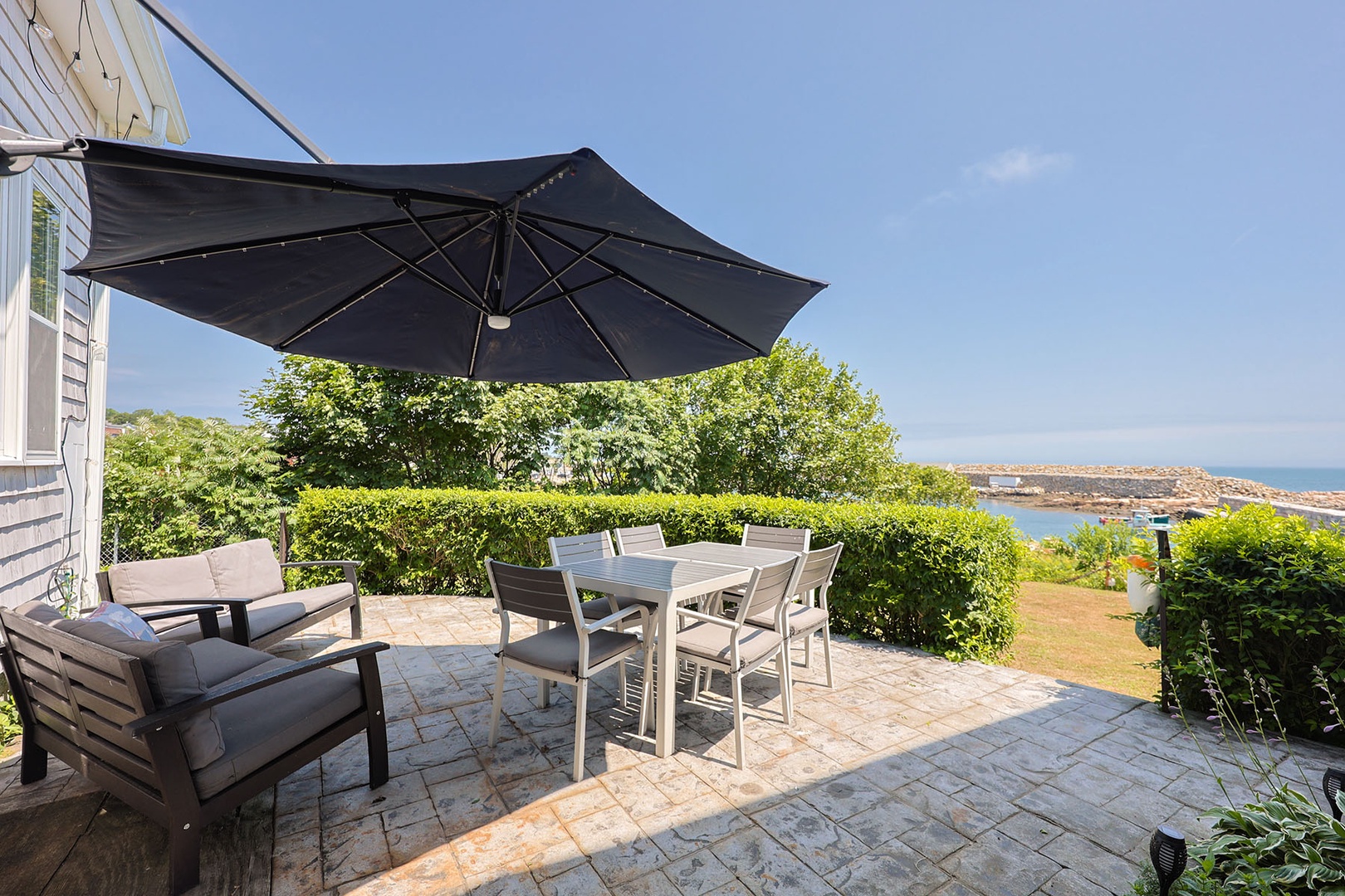 Patio with seating and beautiful waterfront views.