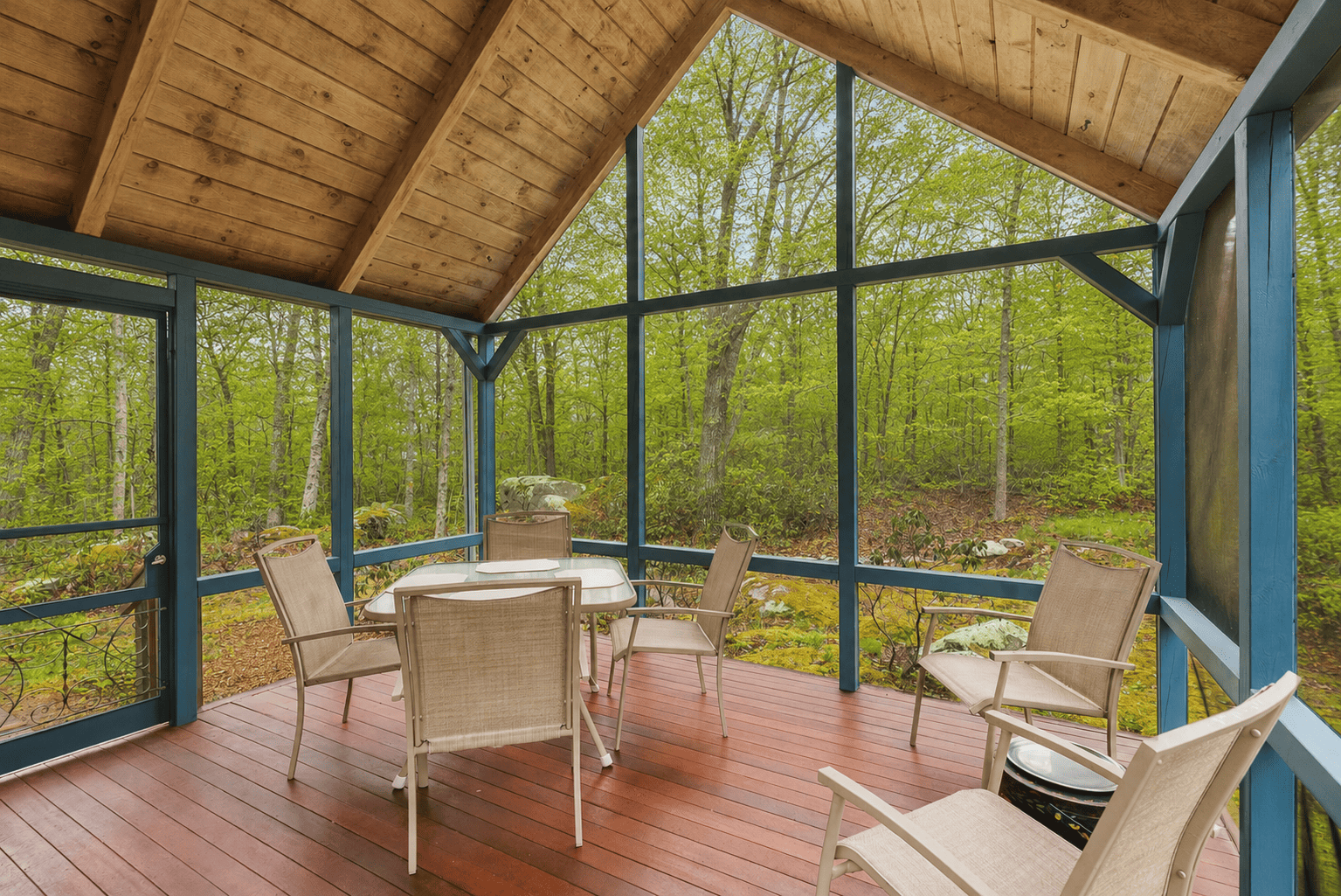 Screened porch looking out to the forest.