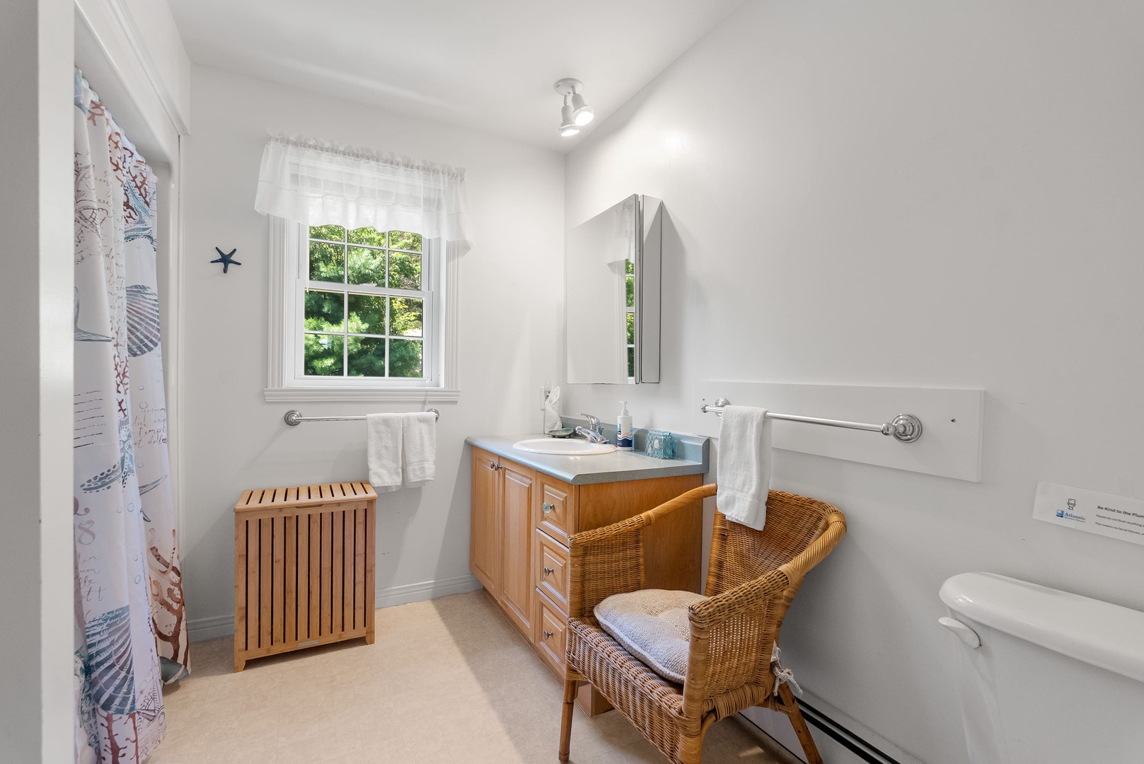 Full bathroom with walk in shower in the hall.