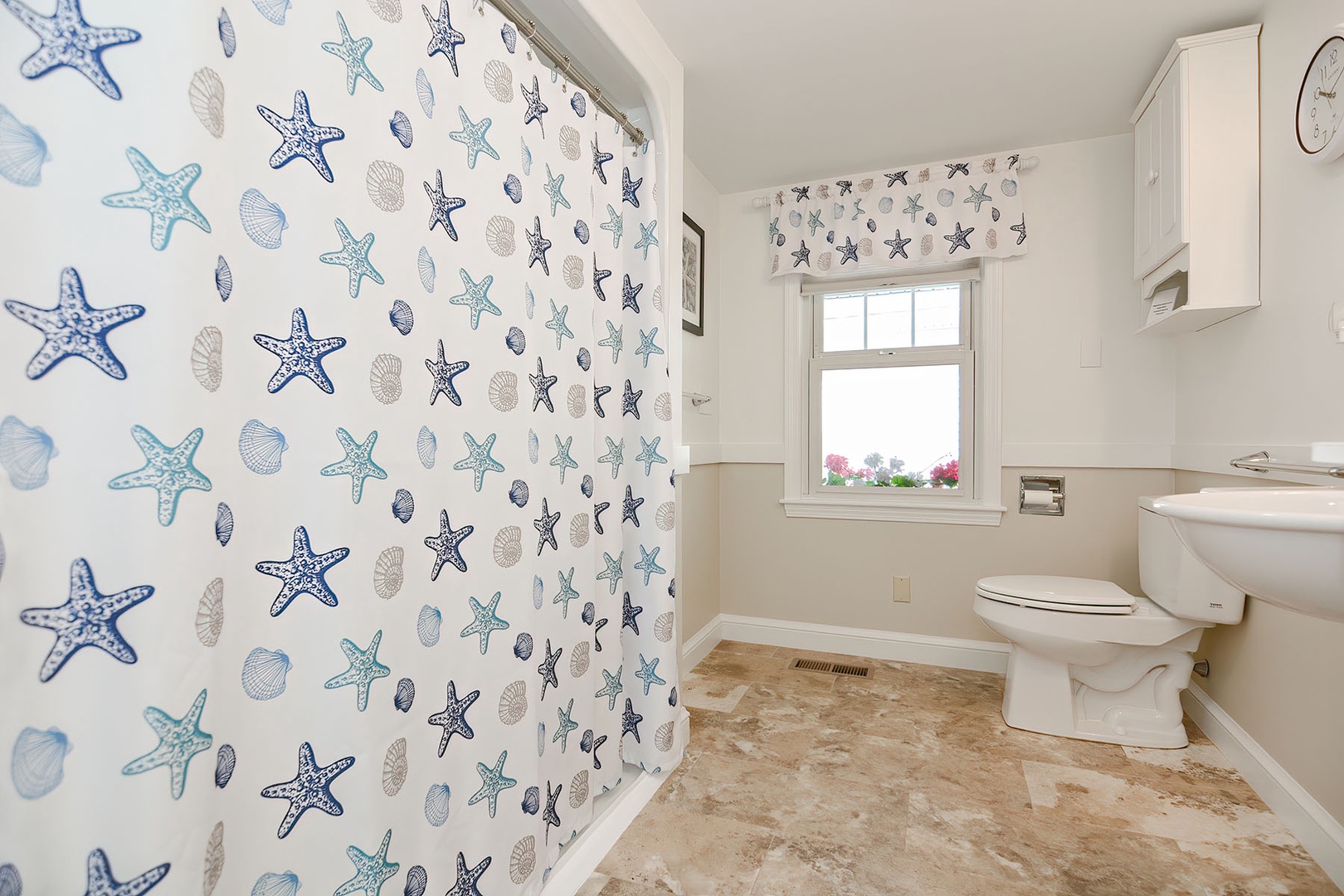 View of ground floor bathroom with shower curtains closed.