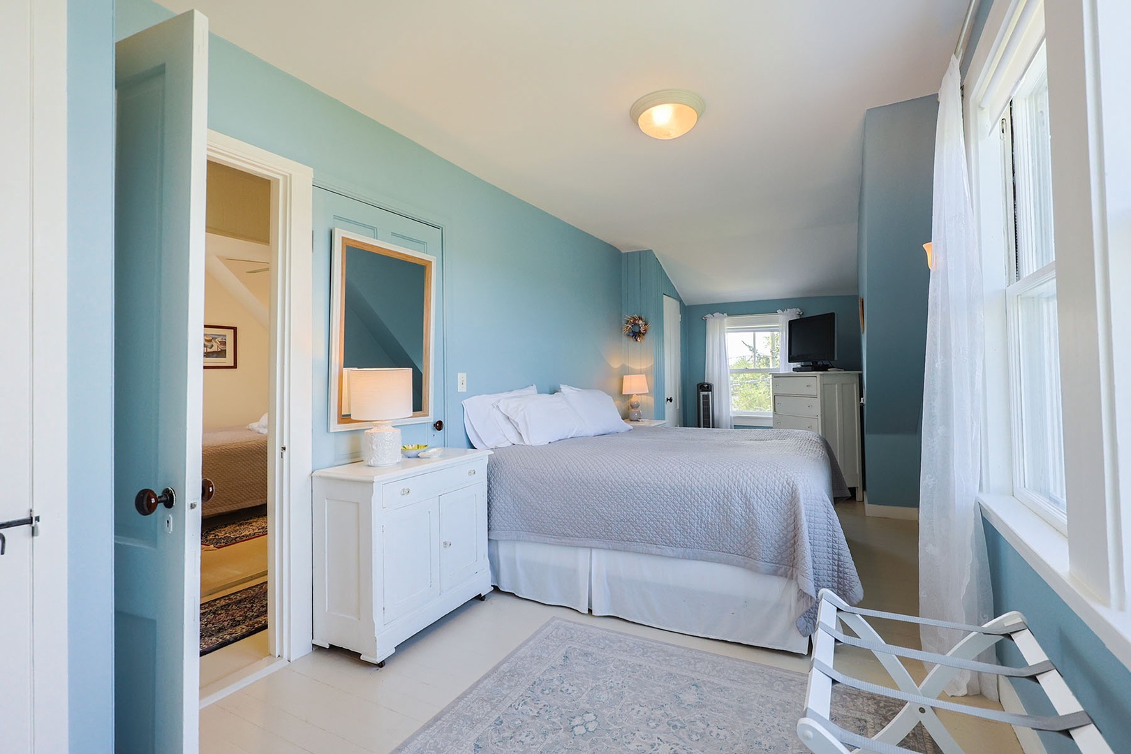 The comfortable primary bedroom includes an AC unit.