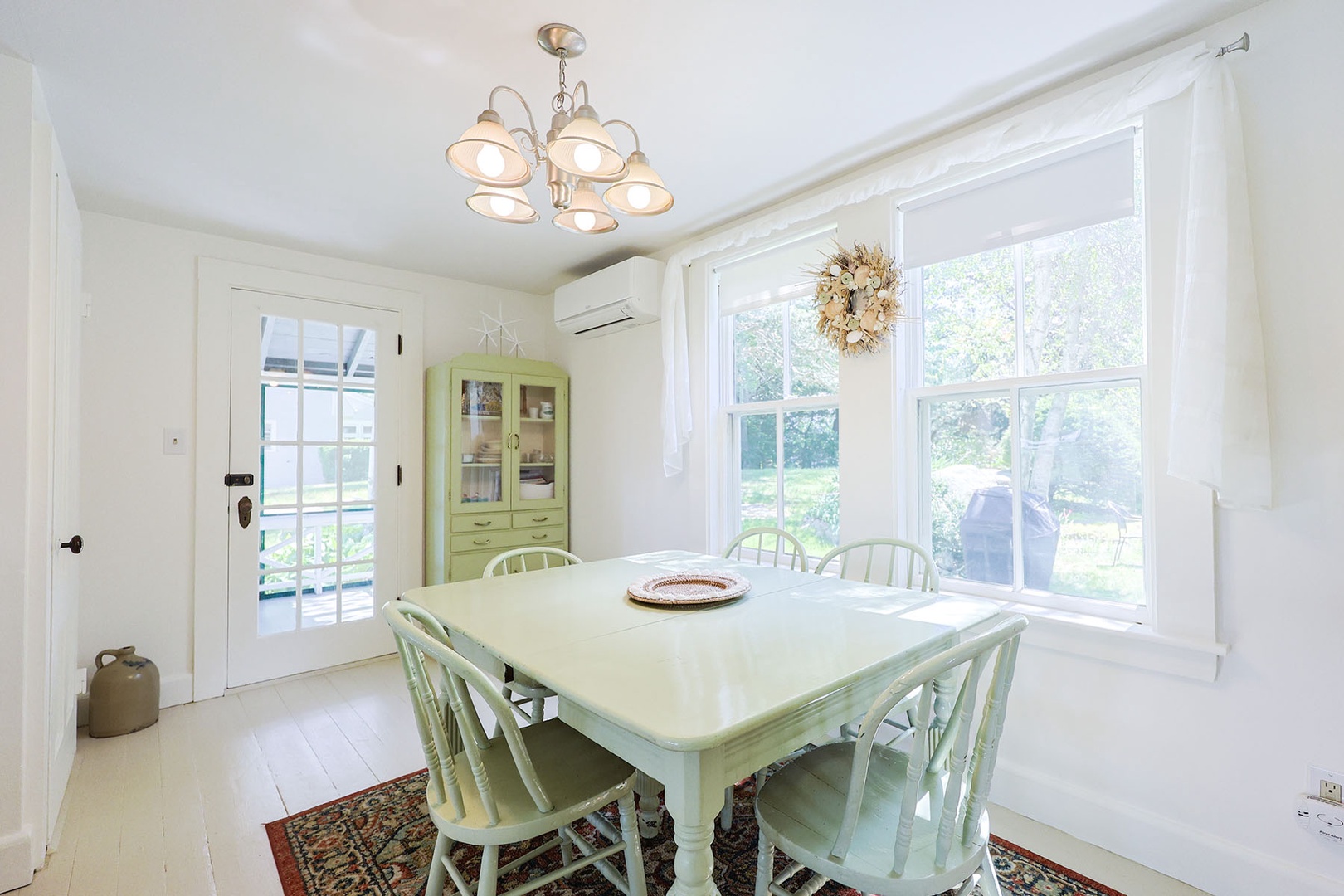 Dining area with natural light and serene window views.