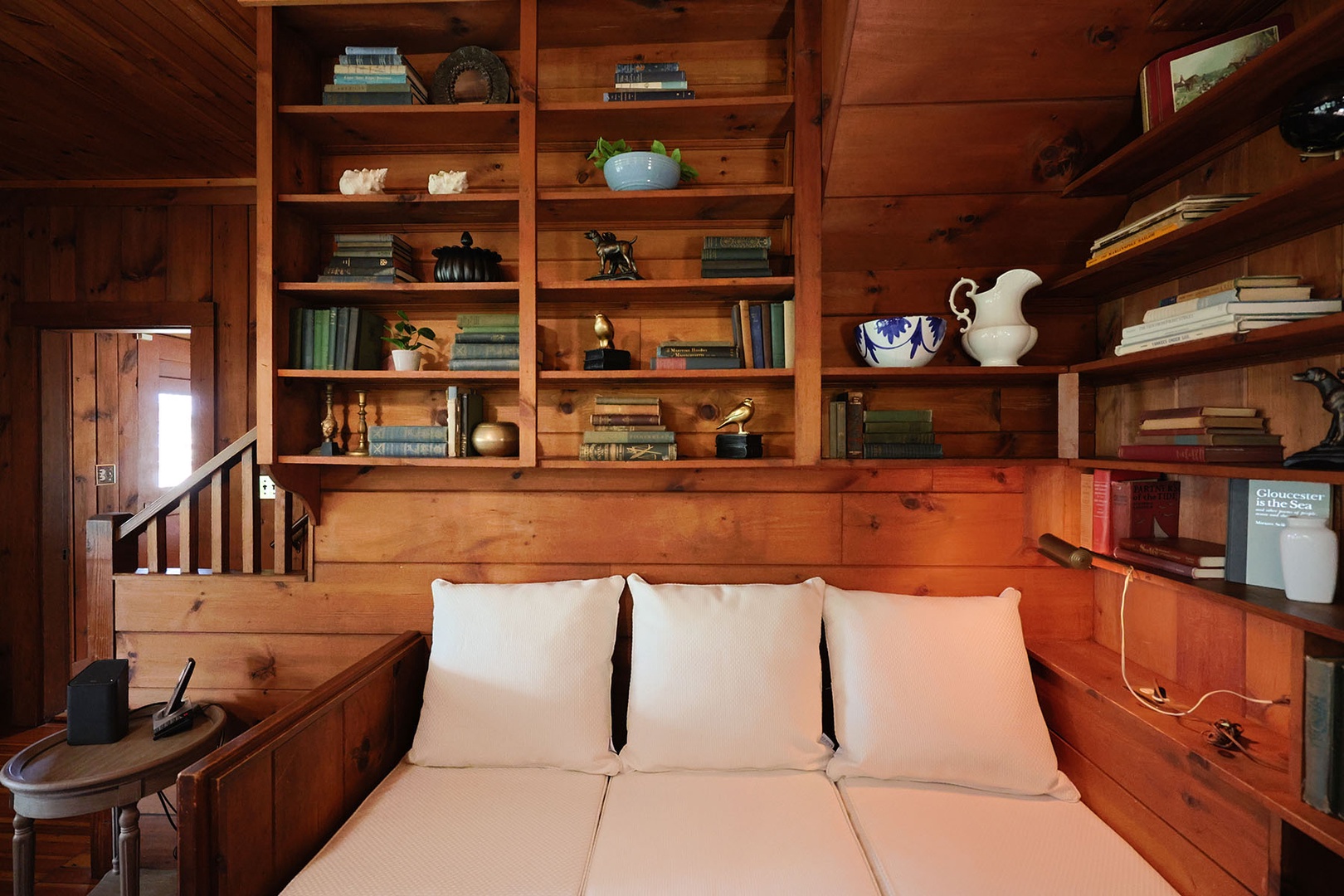 Living room features a built-in wooden bookshelf.