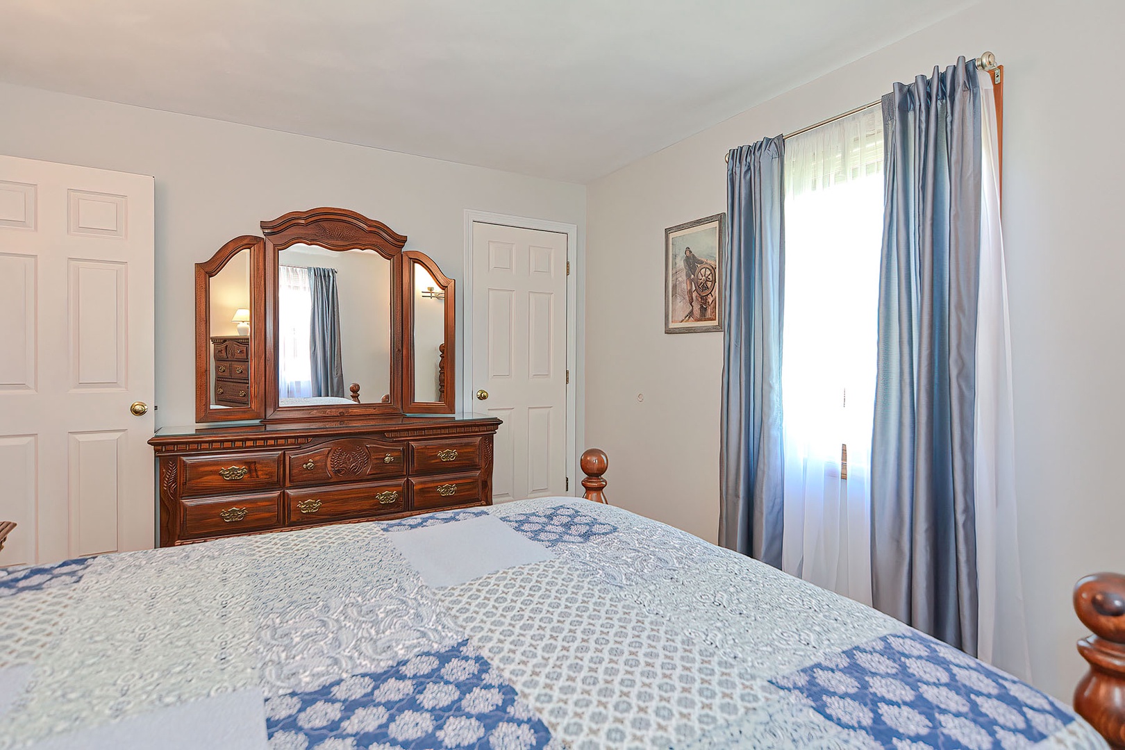 The bedroom has a large closet and plenty of bureau drawers.