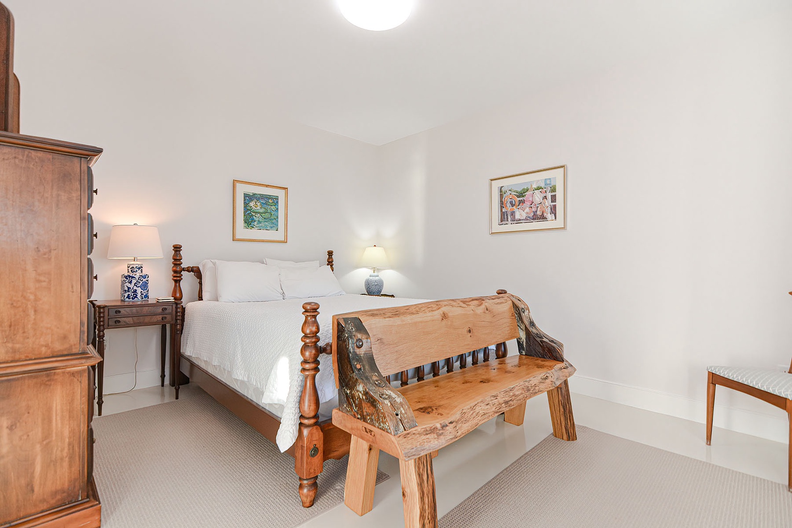Primary bedroom has a bed bench and plenty of storage space.