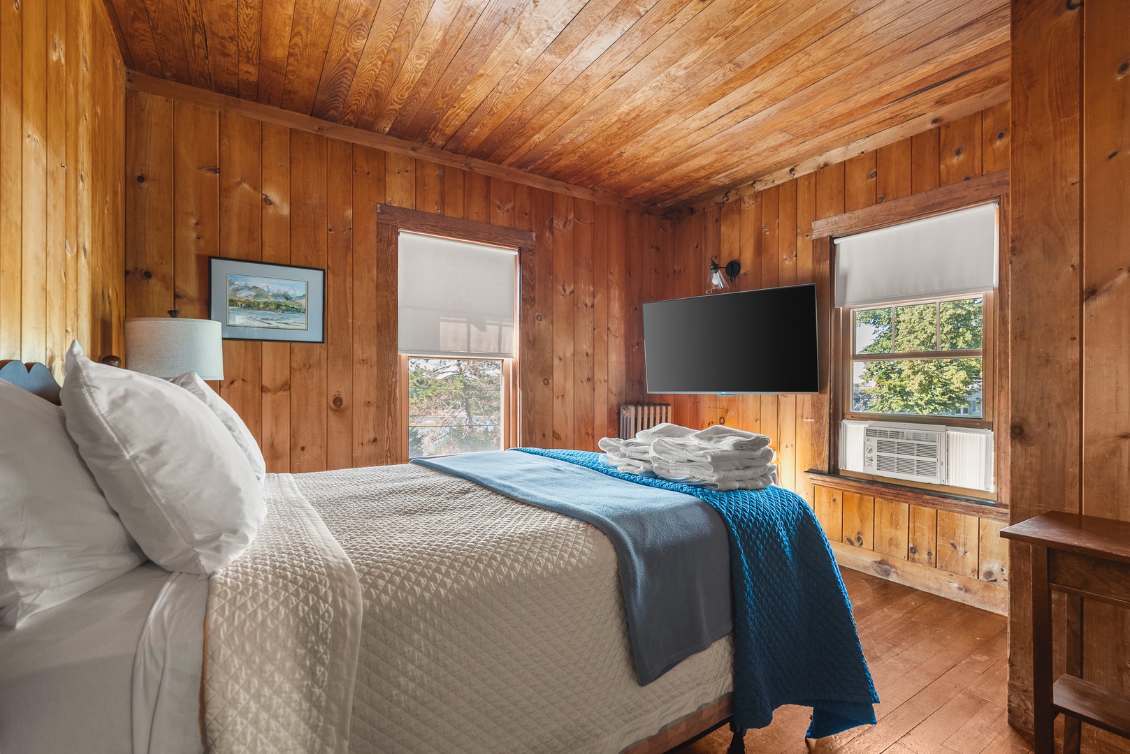 Upstairs Queen Bedroom with TV with beautiful views of the river through the windows.