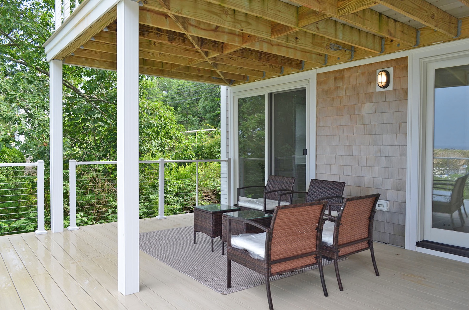 Relax on the deck overlooking Sandy Bay and Pigeon Cove.