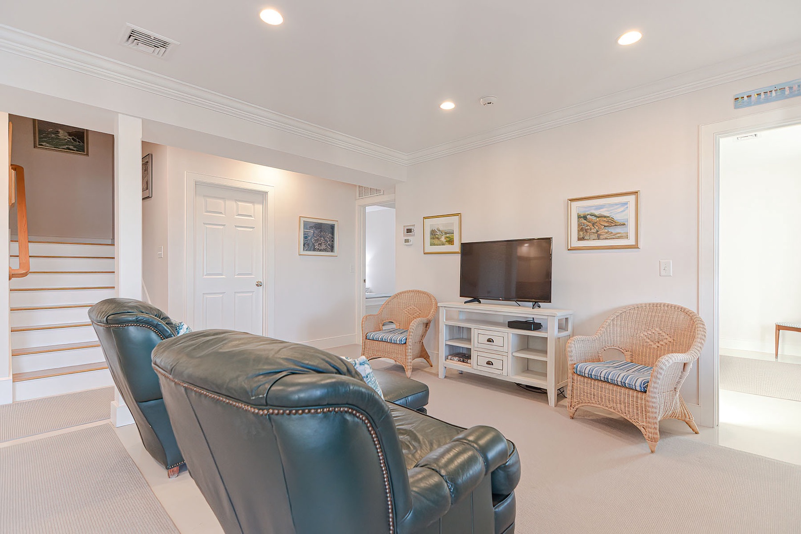 Living room includes a TV and four seats in total.