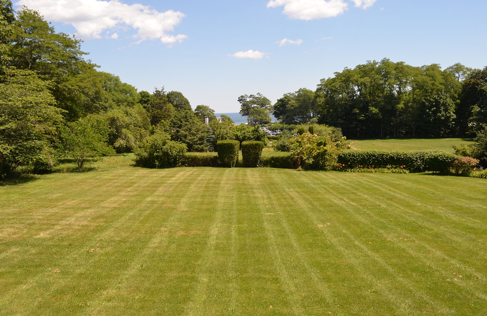 The majestic lawn slopes gently toward Singing Beach.