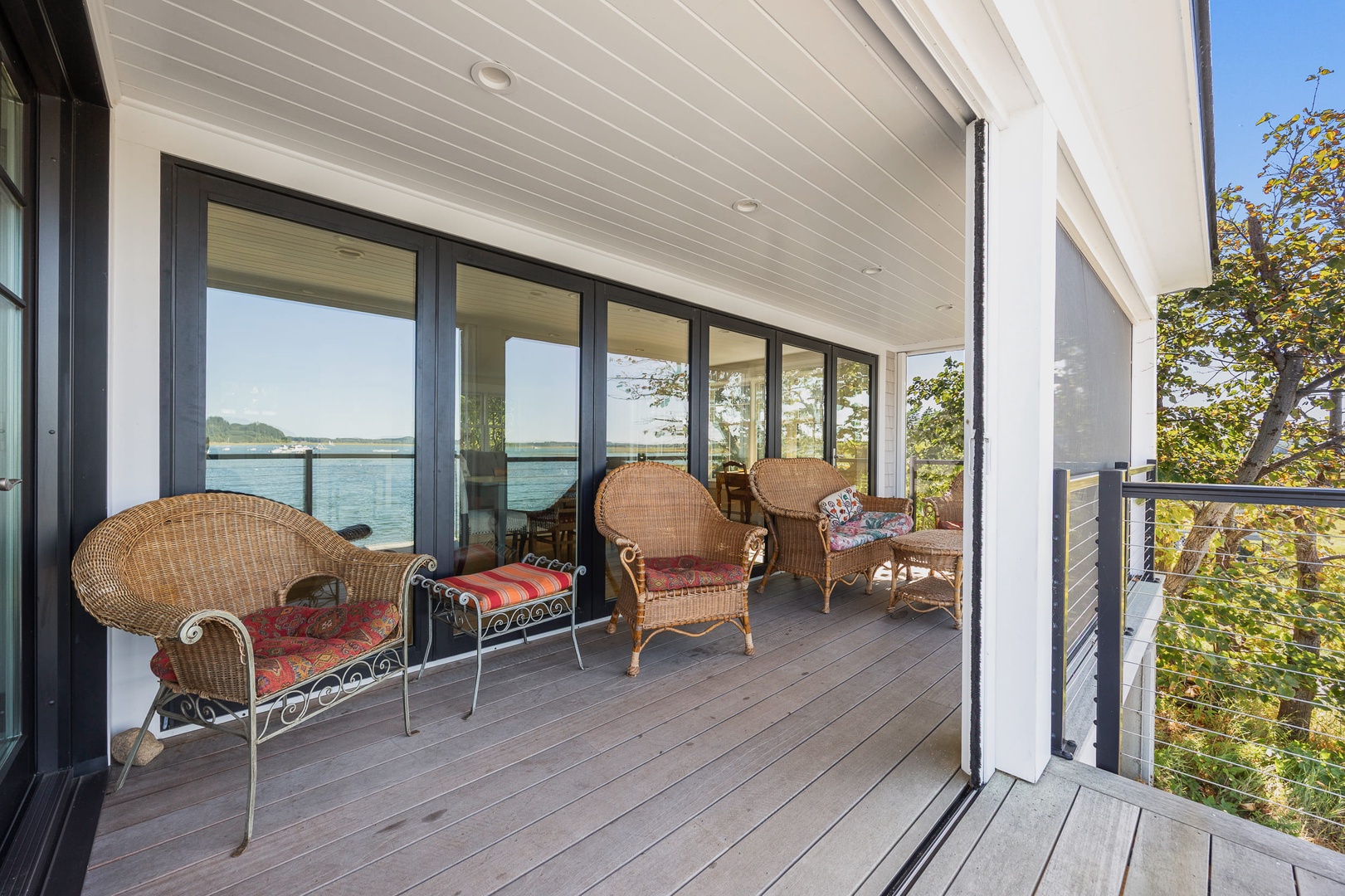 A cozy outdoor sitting area with views of tranquil waters.