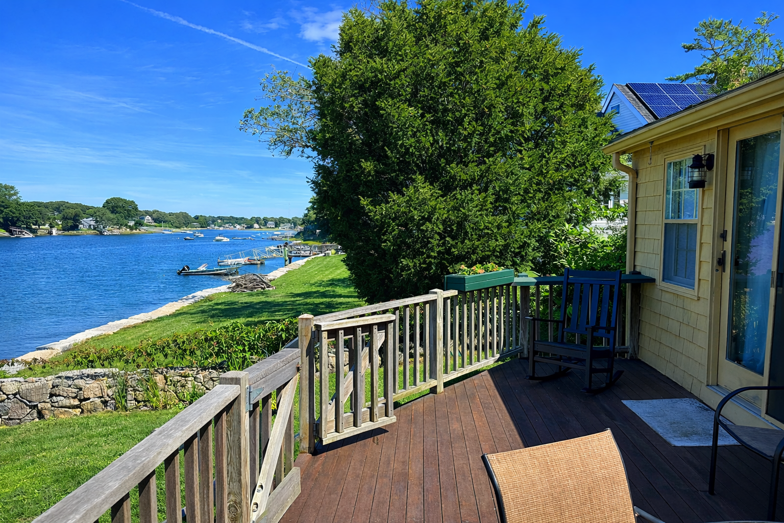 The generously sized deck overlooks the water.