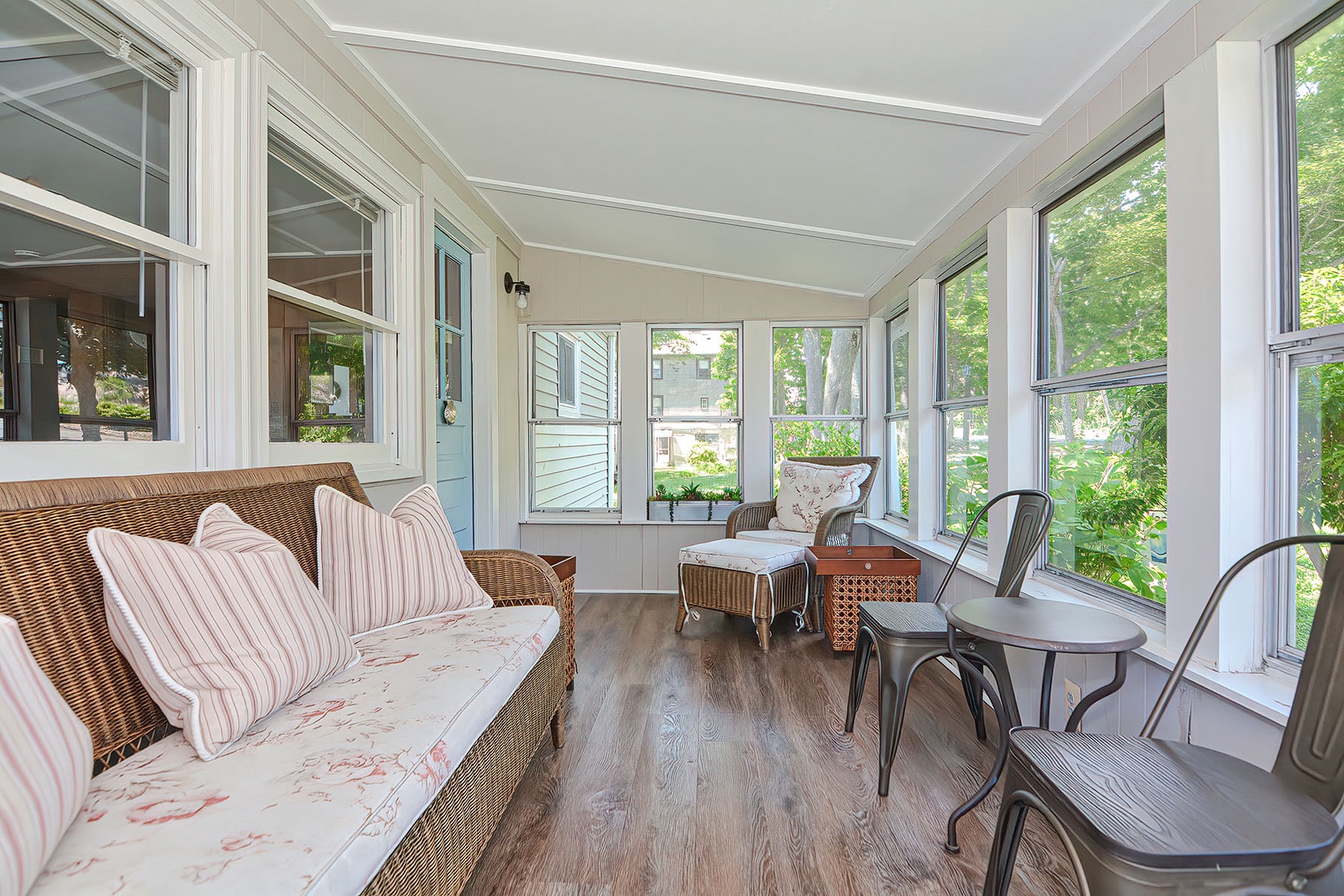 Enter the cottage through the bright and cozy sunroom.