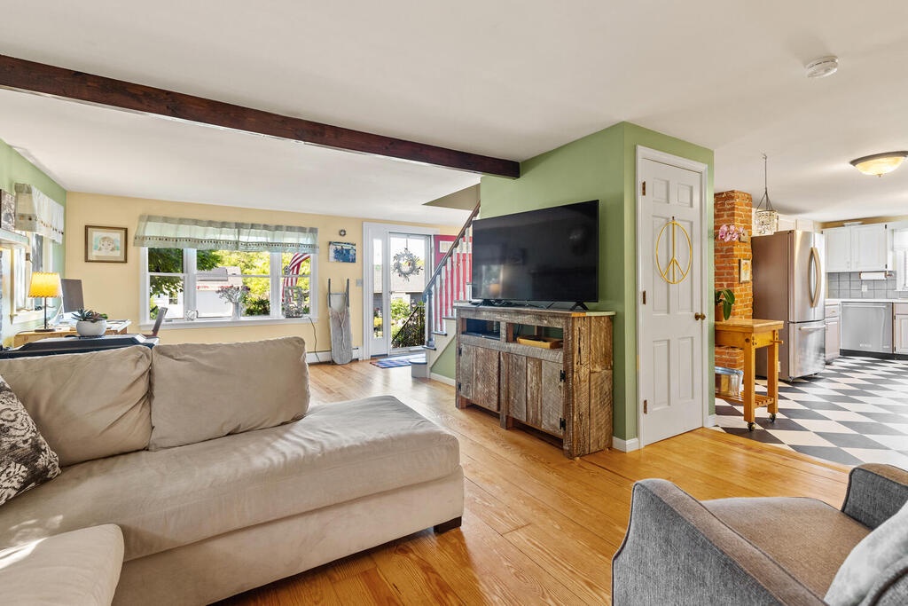 The living room has a tv and sectional sofa.