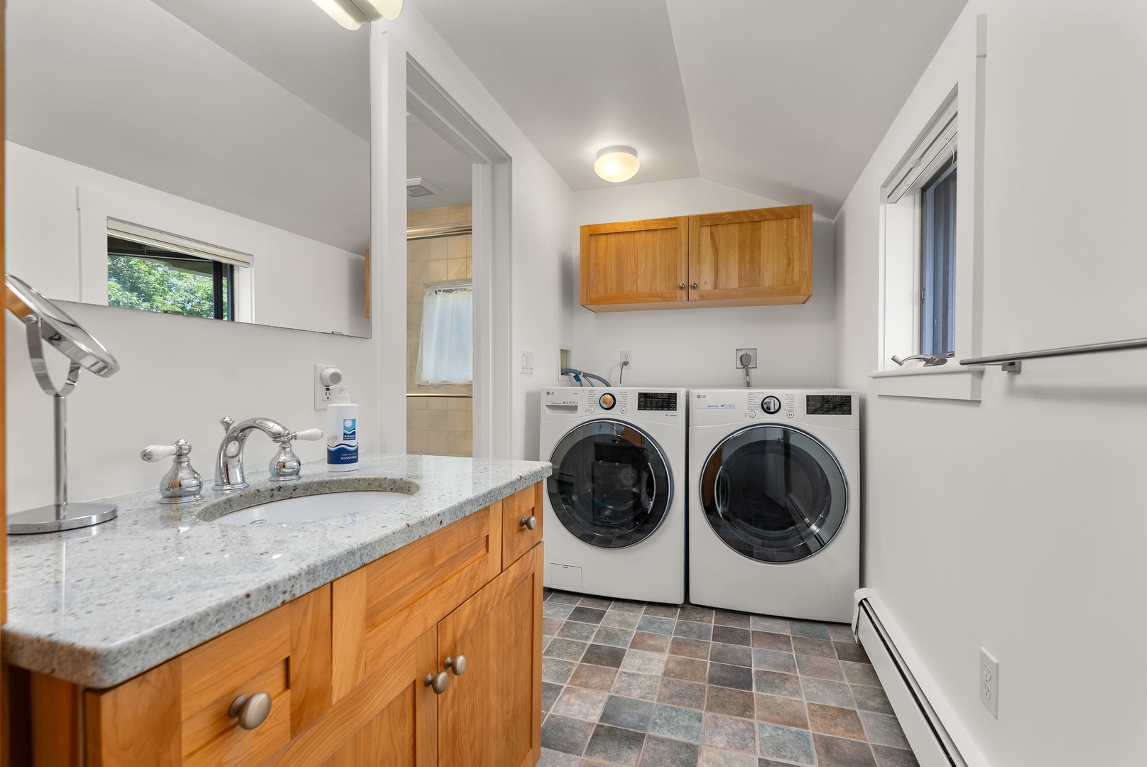 The washer and dryer is also located in this bathroom.