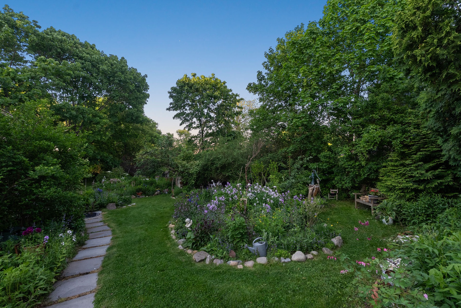 The lush and green garden surrounding the house.