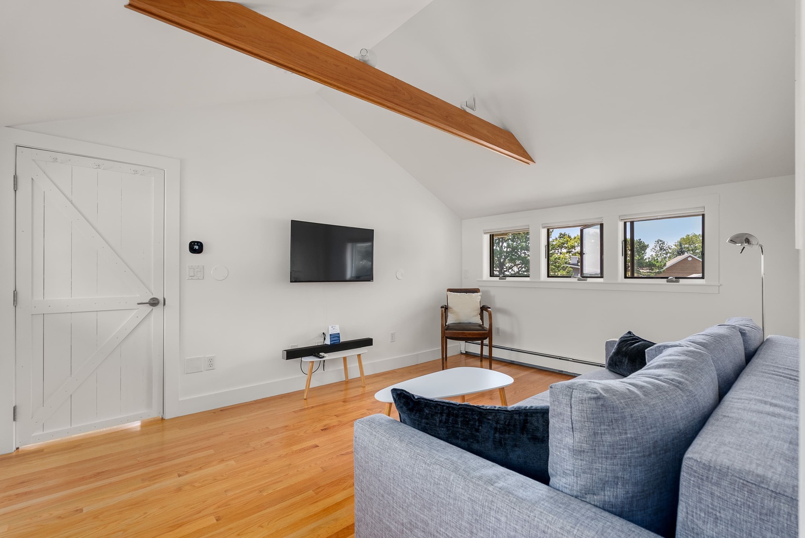 The sitting room on the second floor, along with a TV.
