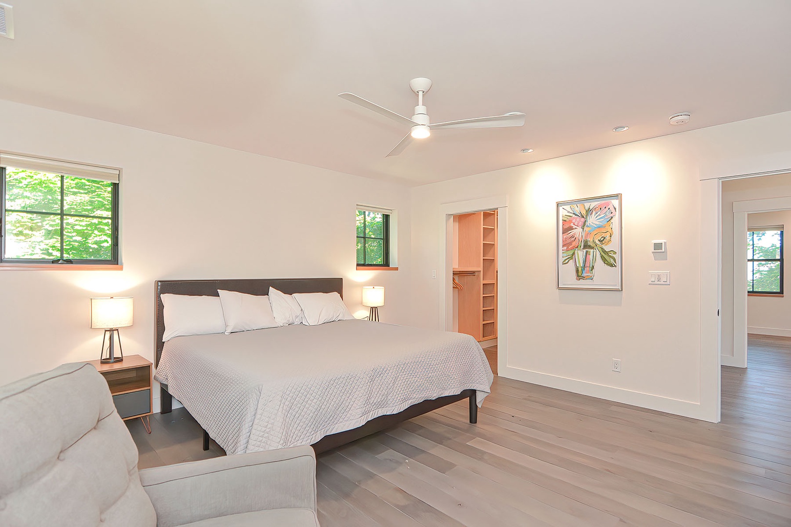 The Primary bedroom has a King bed, an armchair, and a flat-screen TV.