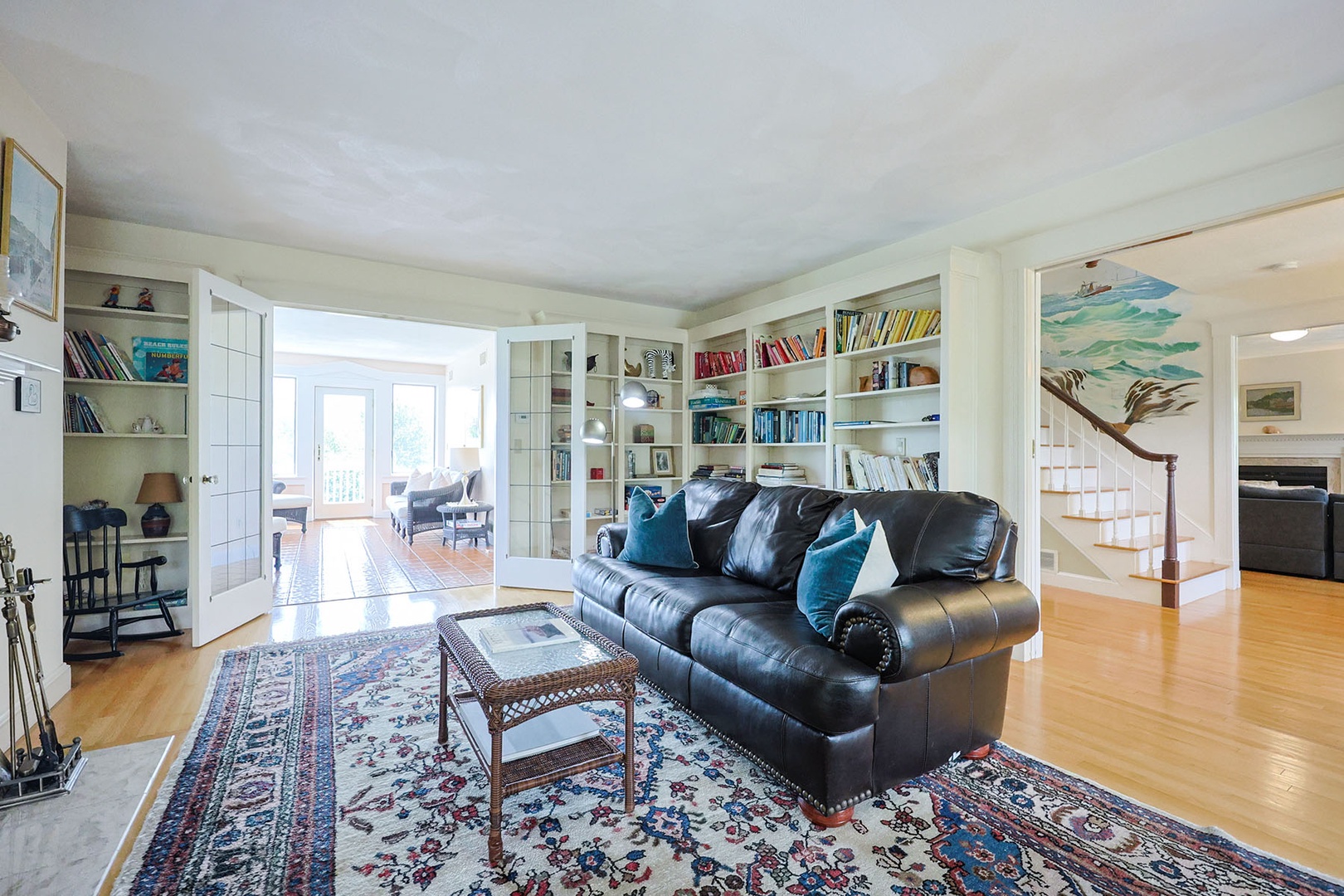 Living Room 2: Leather sofas, fireplace and built-in shelves with books.