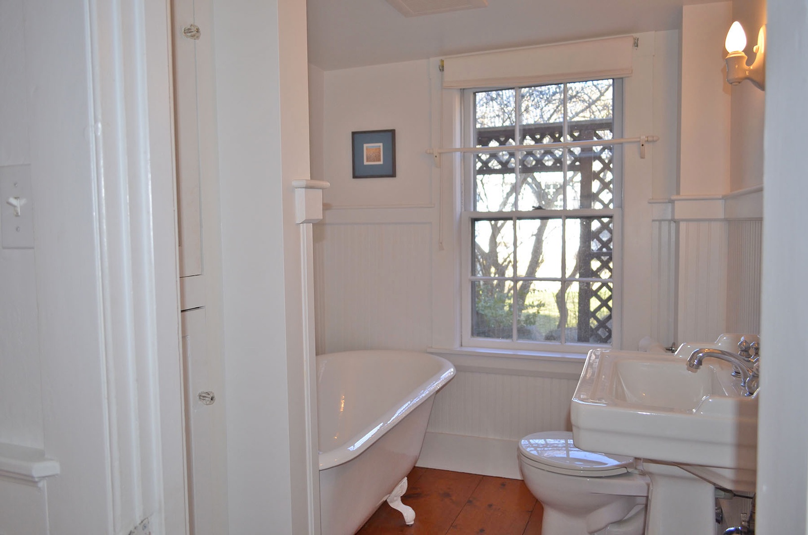 Full bathroom with claw-foot tub on the ground floor.