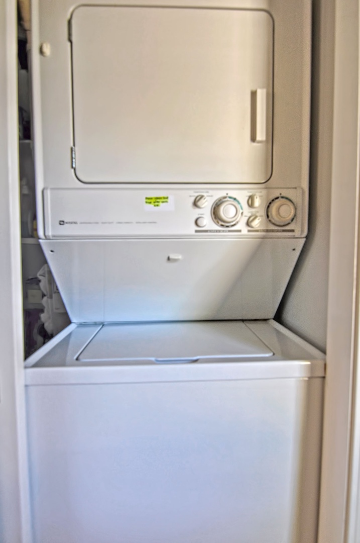 Off the kitchen is a closet with the laundry machines inside.