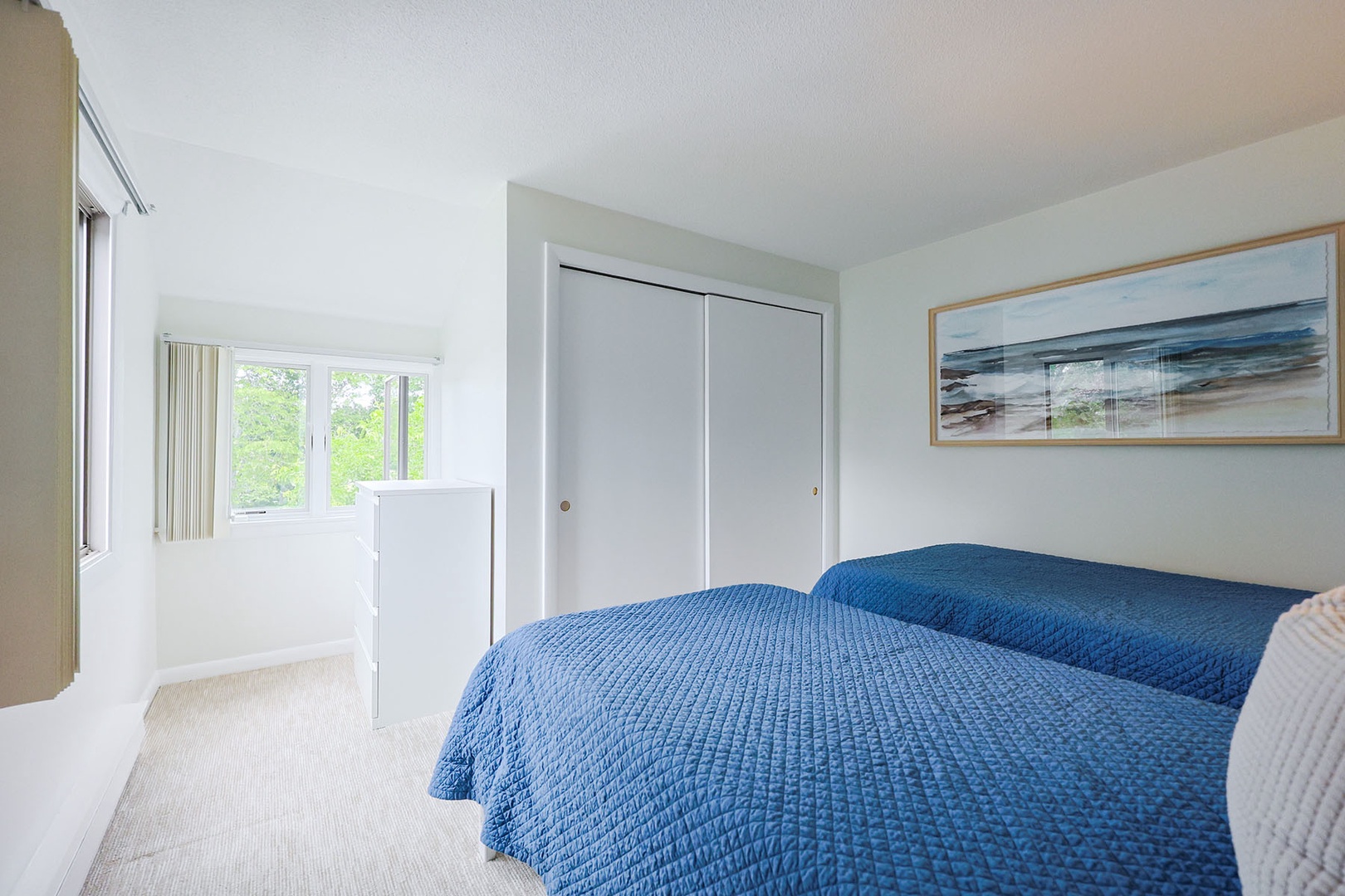 Second bedroom includes plenty of closet space and scenic views outside.