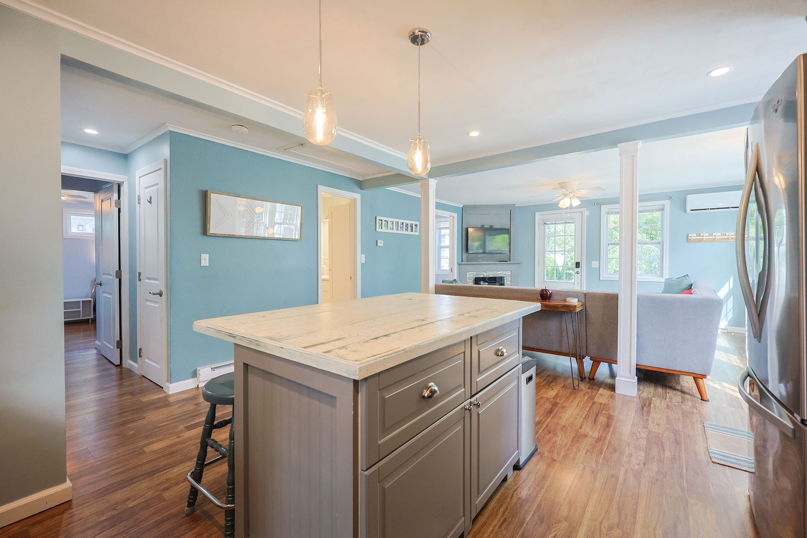 The kitchen has ample storage space and a kitchen island.
