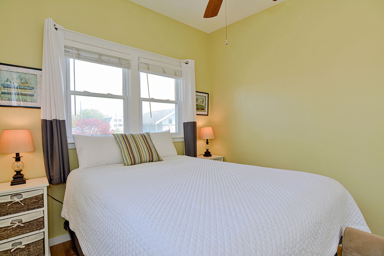 Bedroom 3 features cozy lamp lighting and a view of the street.