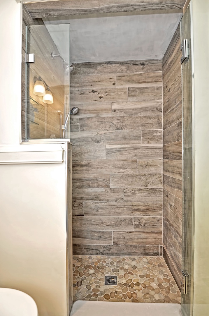 Walk in tiled shower.