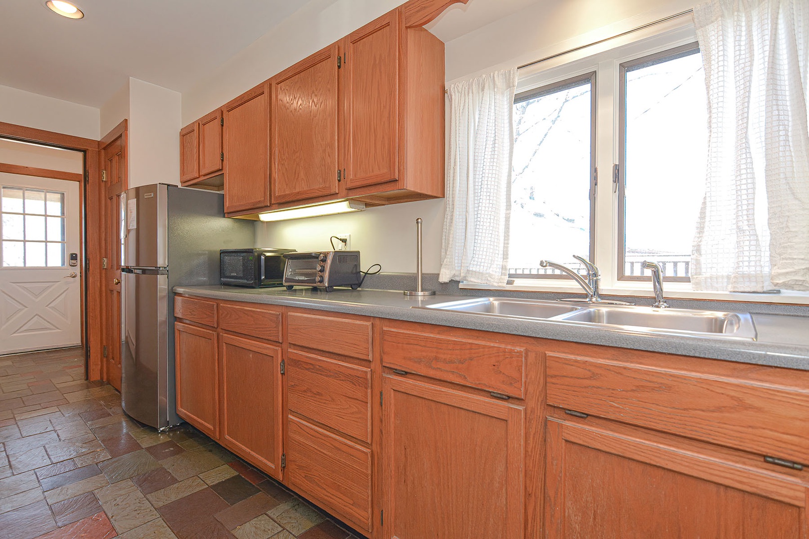 A well-applianced kitchen with plenty of cabinet and counter space.