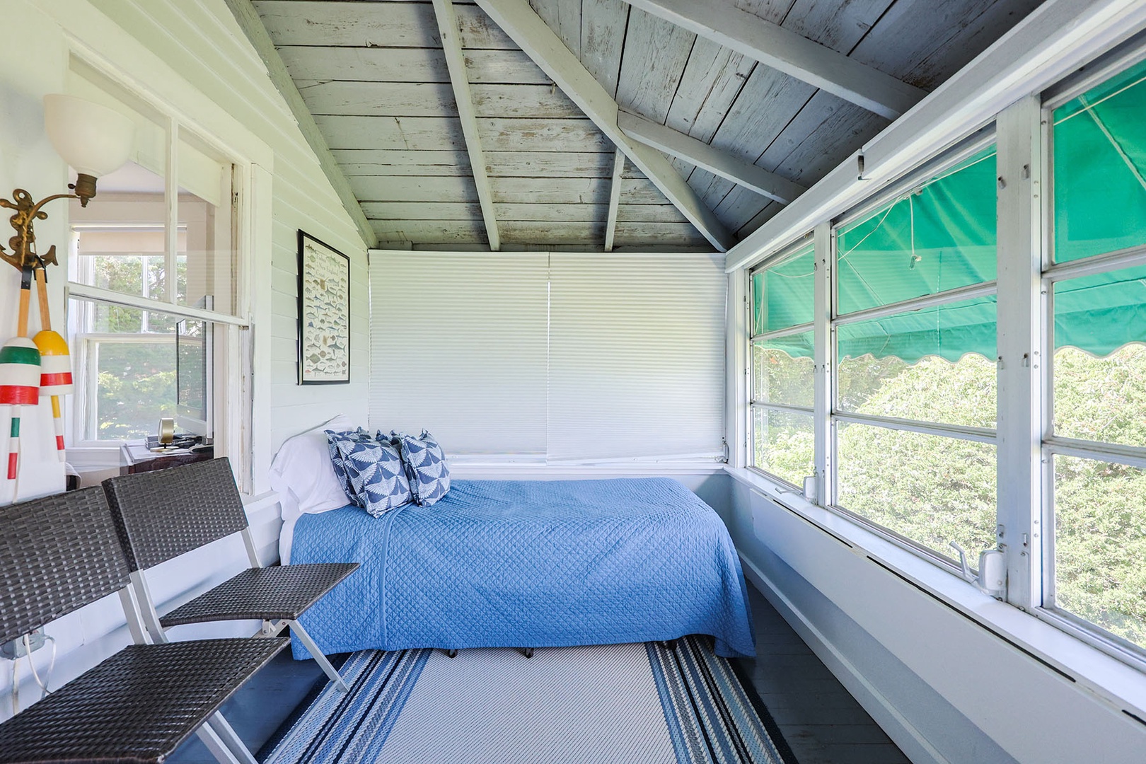 The back porch has an enclosed section with a trundle bed for sleeping amid the cool river breezes.