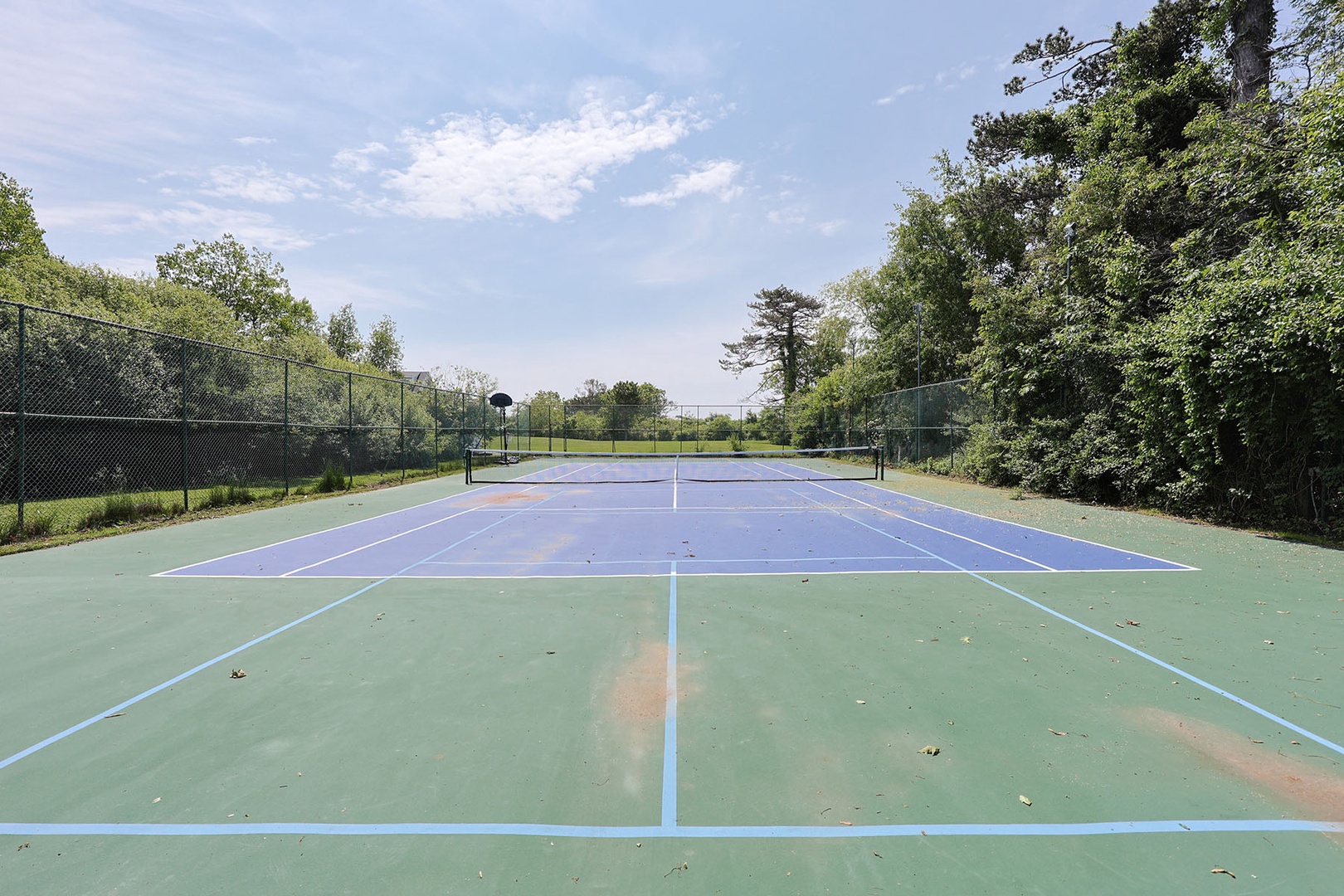The tennis court doubles as a pickleball court for added fun.