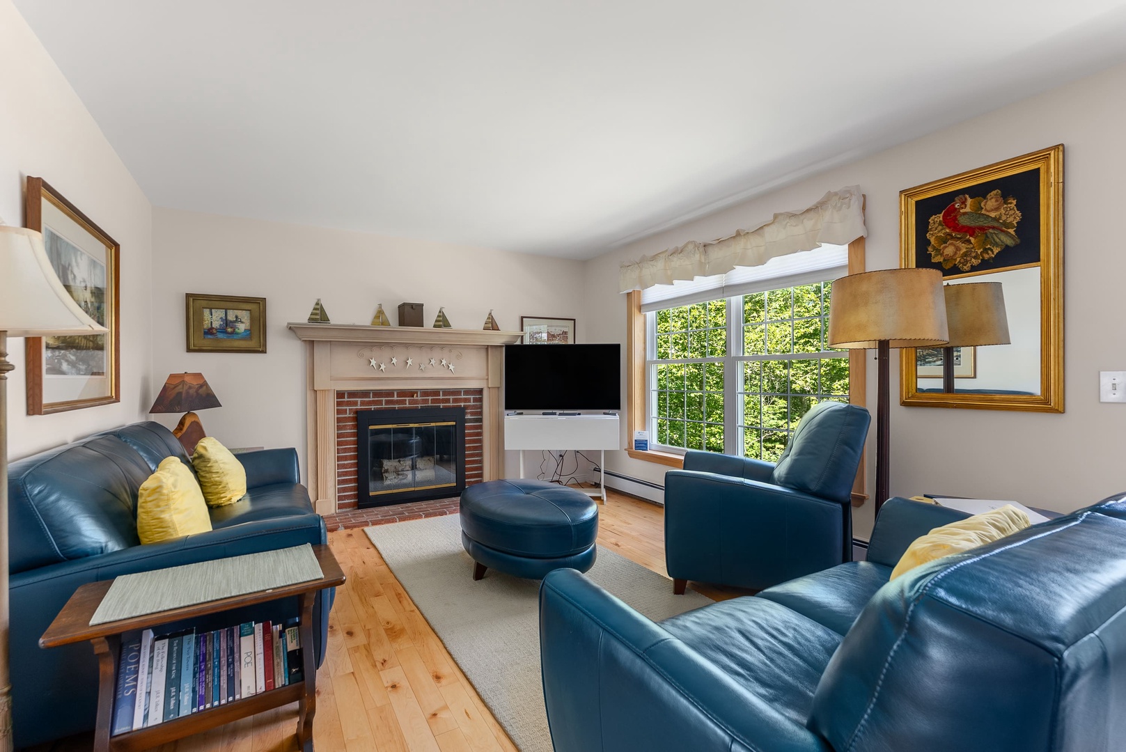 Living room with leather sofas and fireplace.