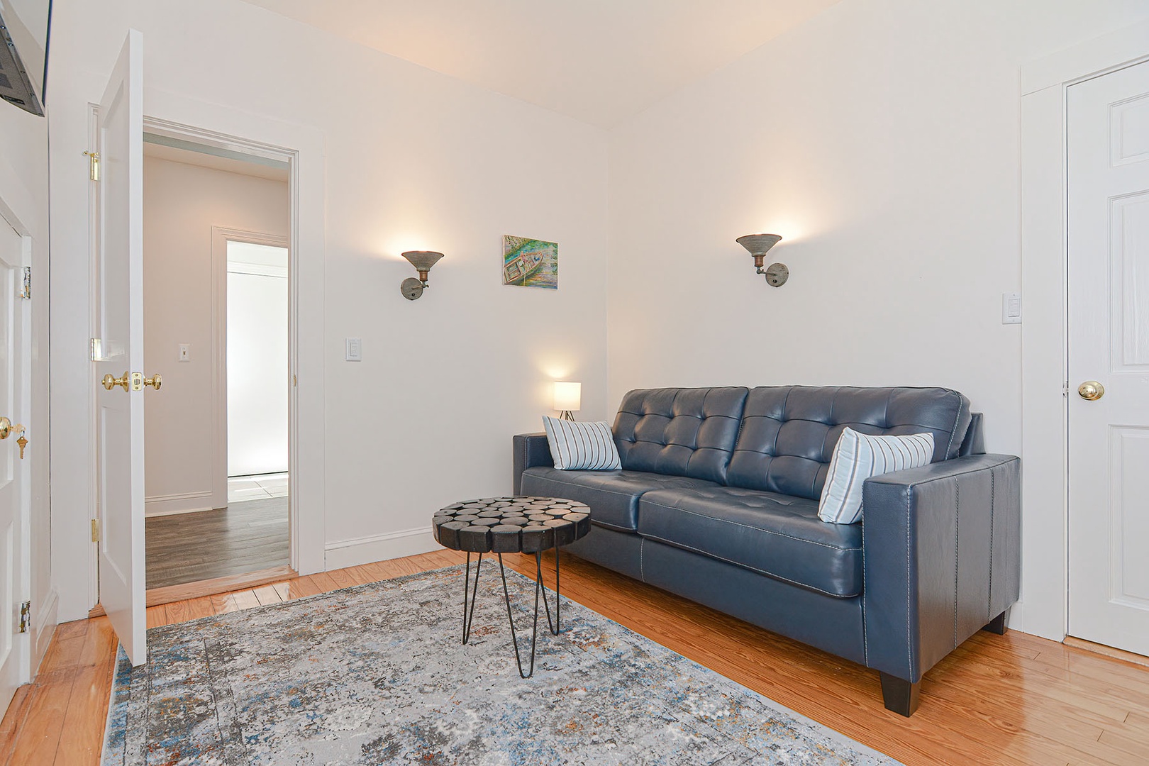 The den has a sleeper sofa and tv.