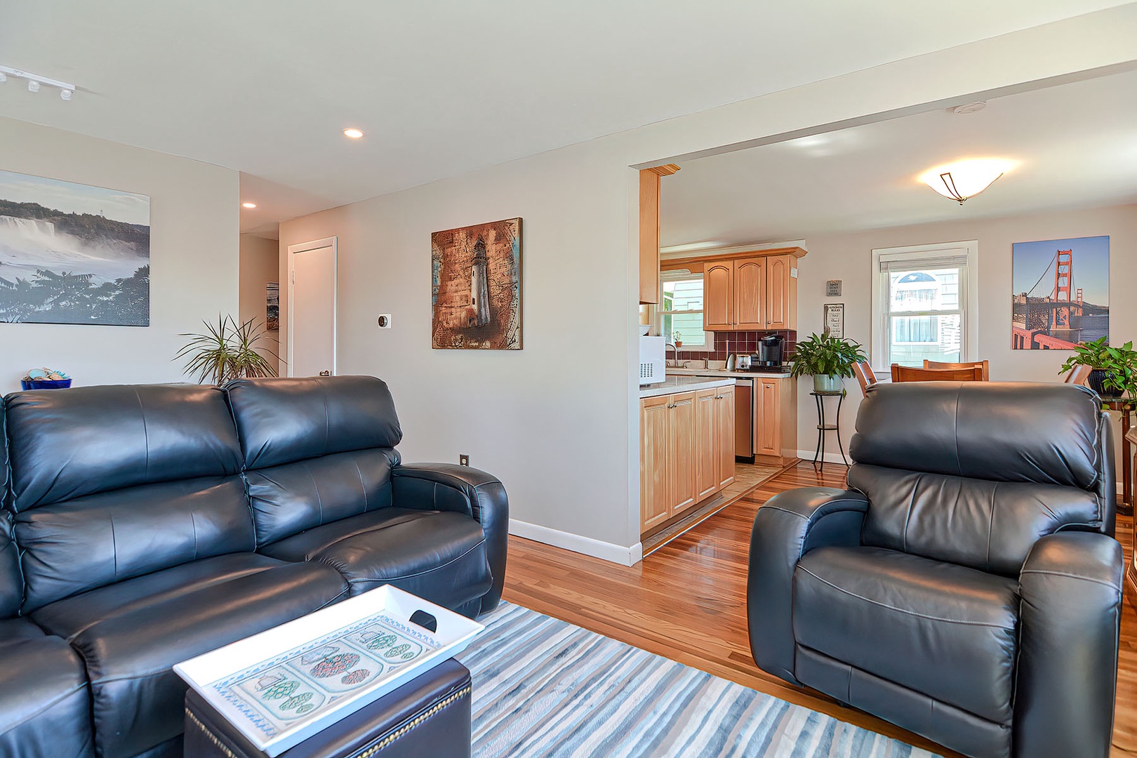 The living room features a power-recline sofa and chair.