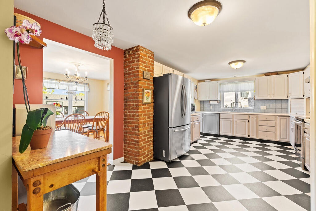 There is a modern kitchen  with stainless steel appliances.
