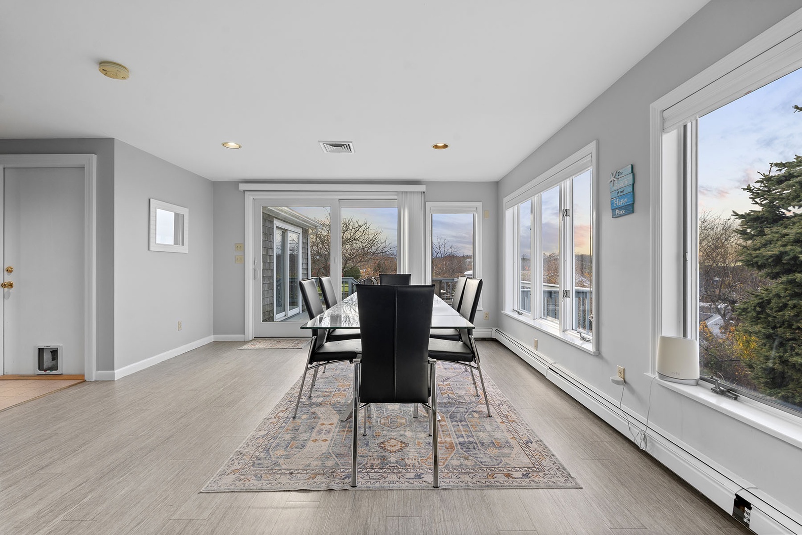 The dining area has plenty of natural lighting and is surrounded by windows.