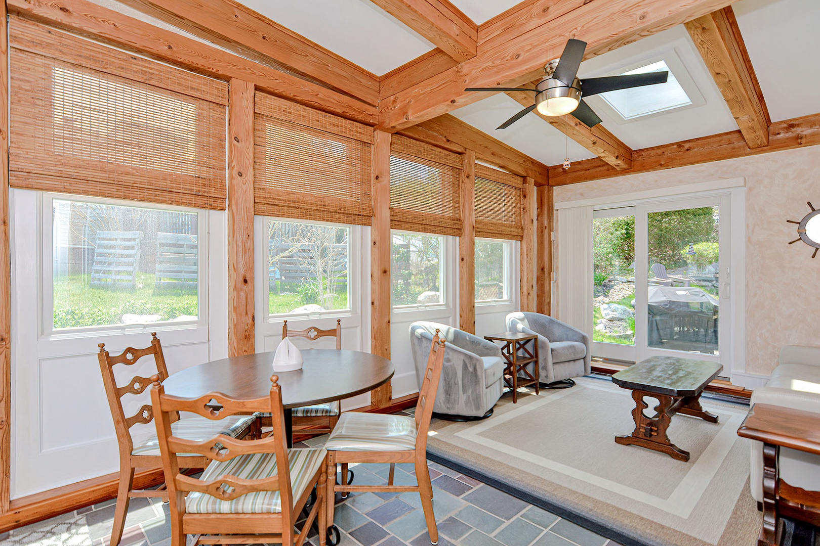 The sun room with additional seating and views out to the back garden.