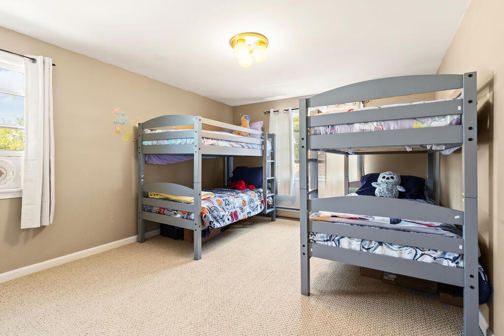 Two sets of bunk beds in the second upstairs bedroom.