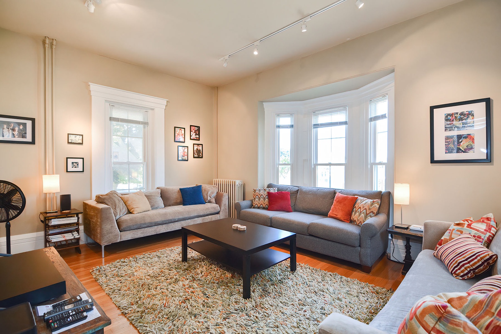The living room seating offers flexible options for relaxation, from family gatherings to movie night.