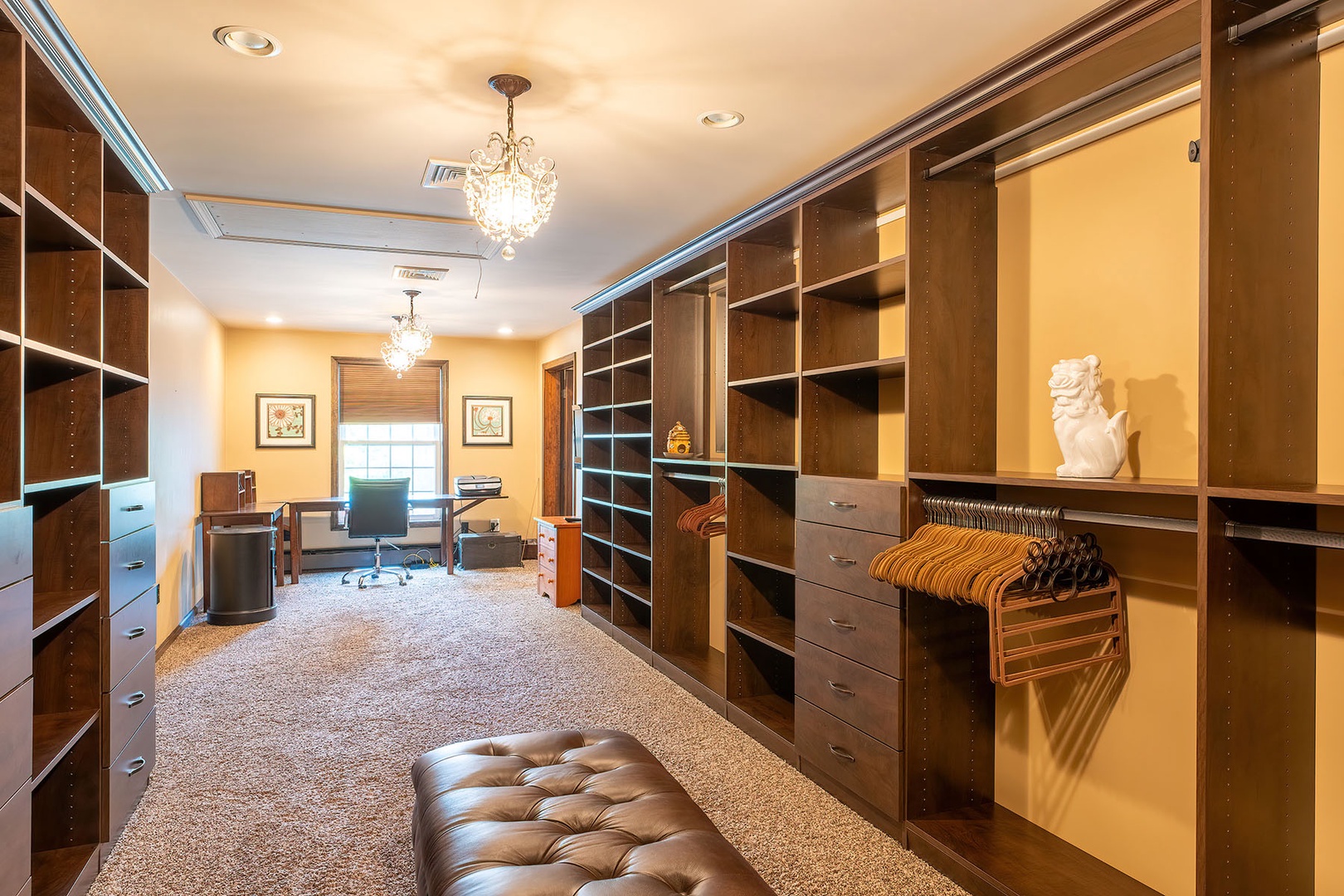 Primary walk-in closet with a desk