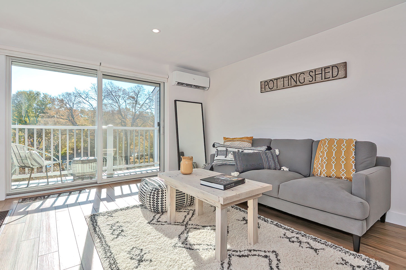 The Living Room is filled with natural light and access to the deck.