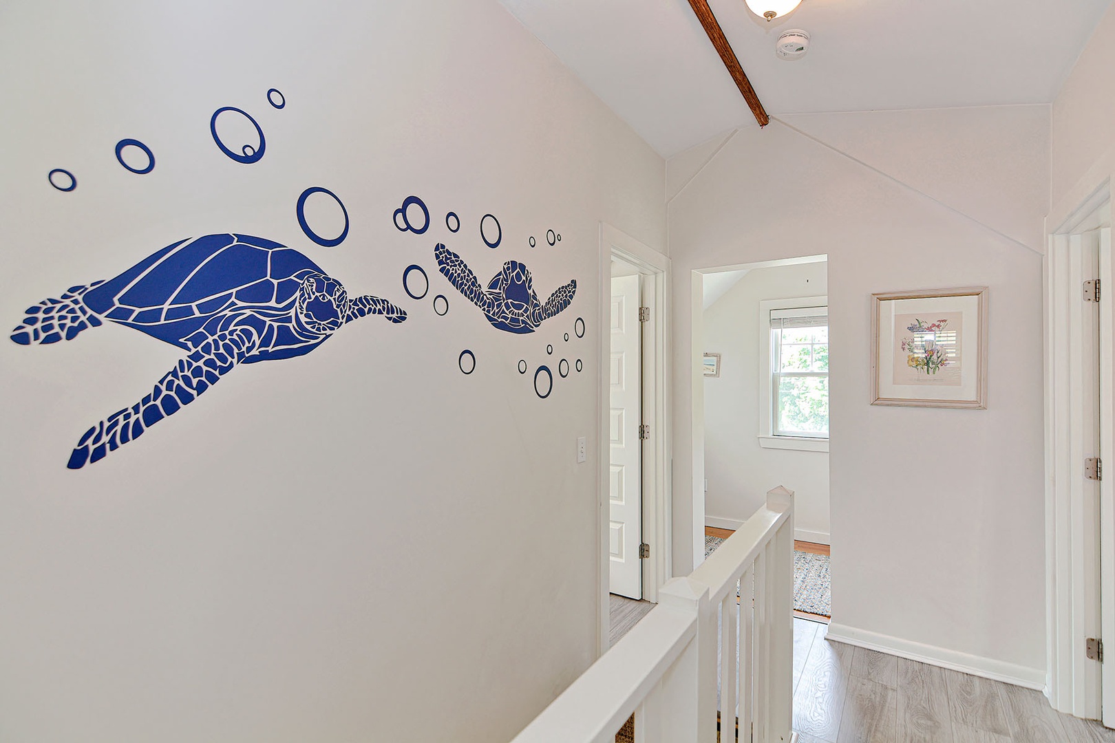 A fun sea-themed mural overseeing the upstairs landing.