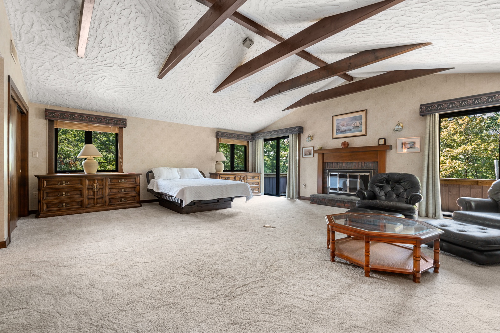The TV lounge in the primary bedroom includes two comfortable sofa chairs with ottomans.