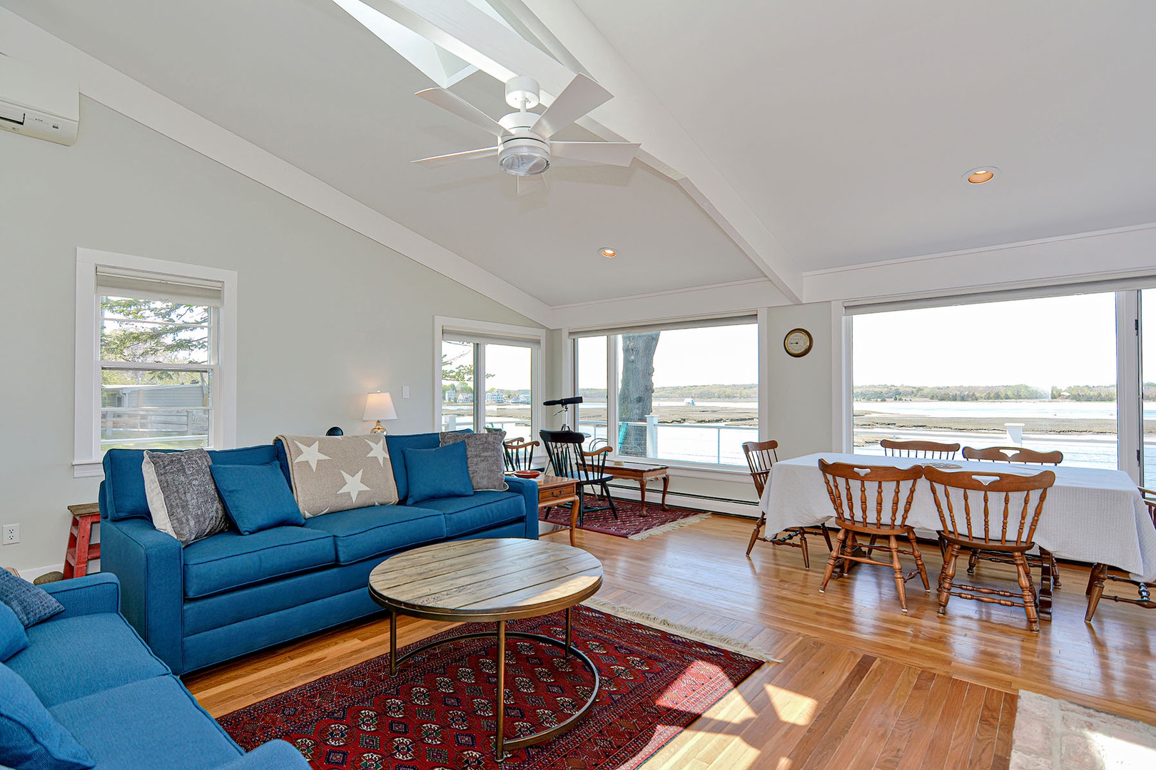 The sun-drenched living room offers stunning river views.