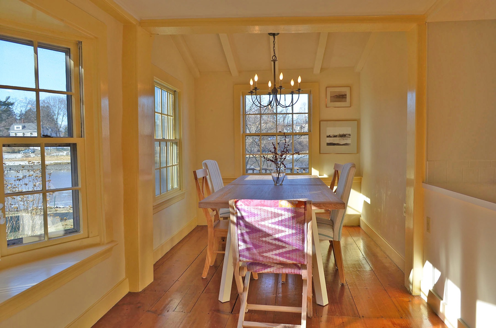 The dining area is bright from the many windows. Table seats 6.