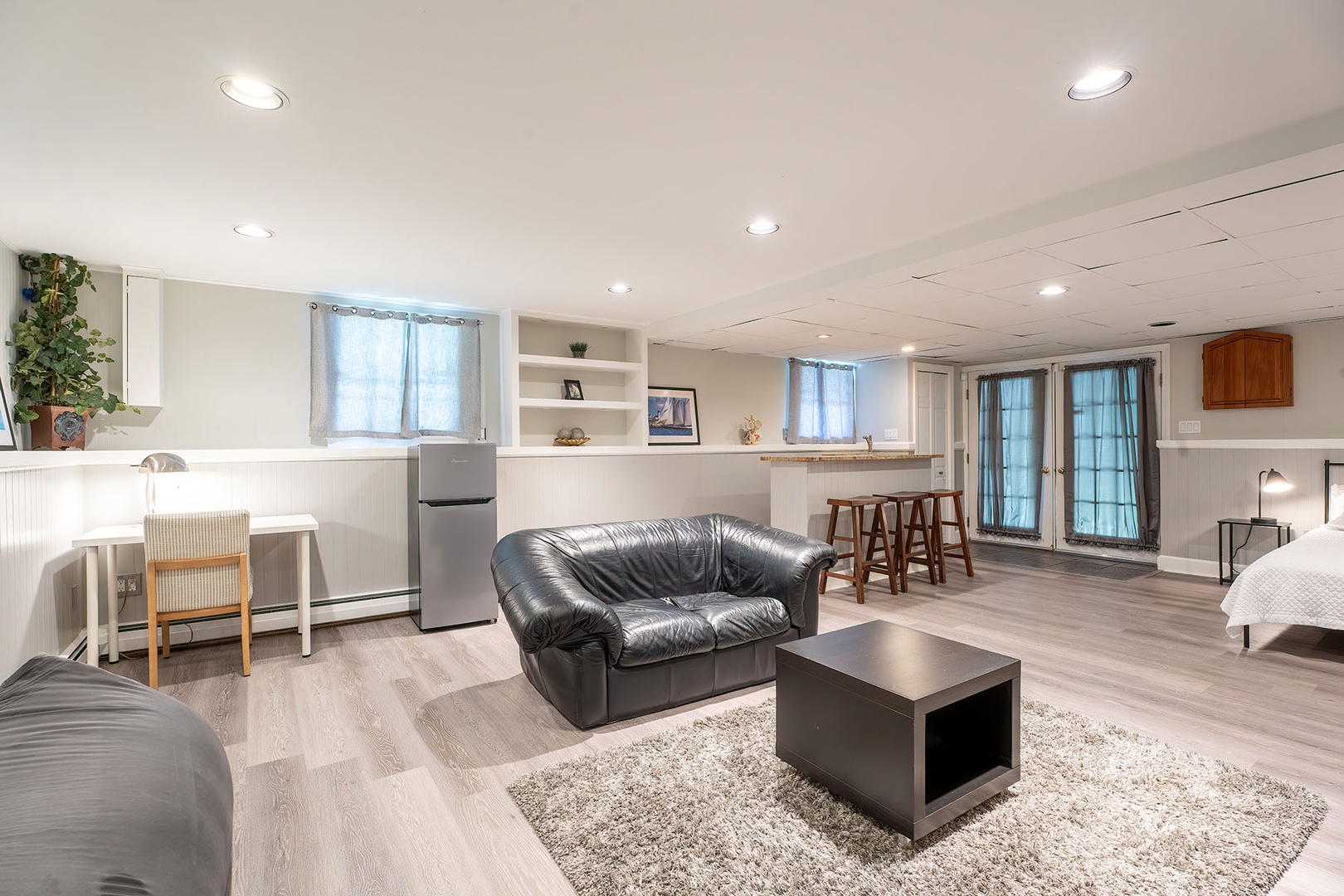 Basement living area with small bar