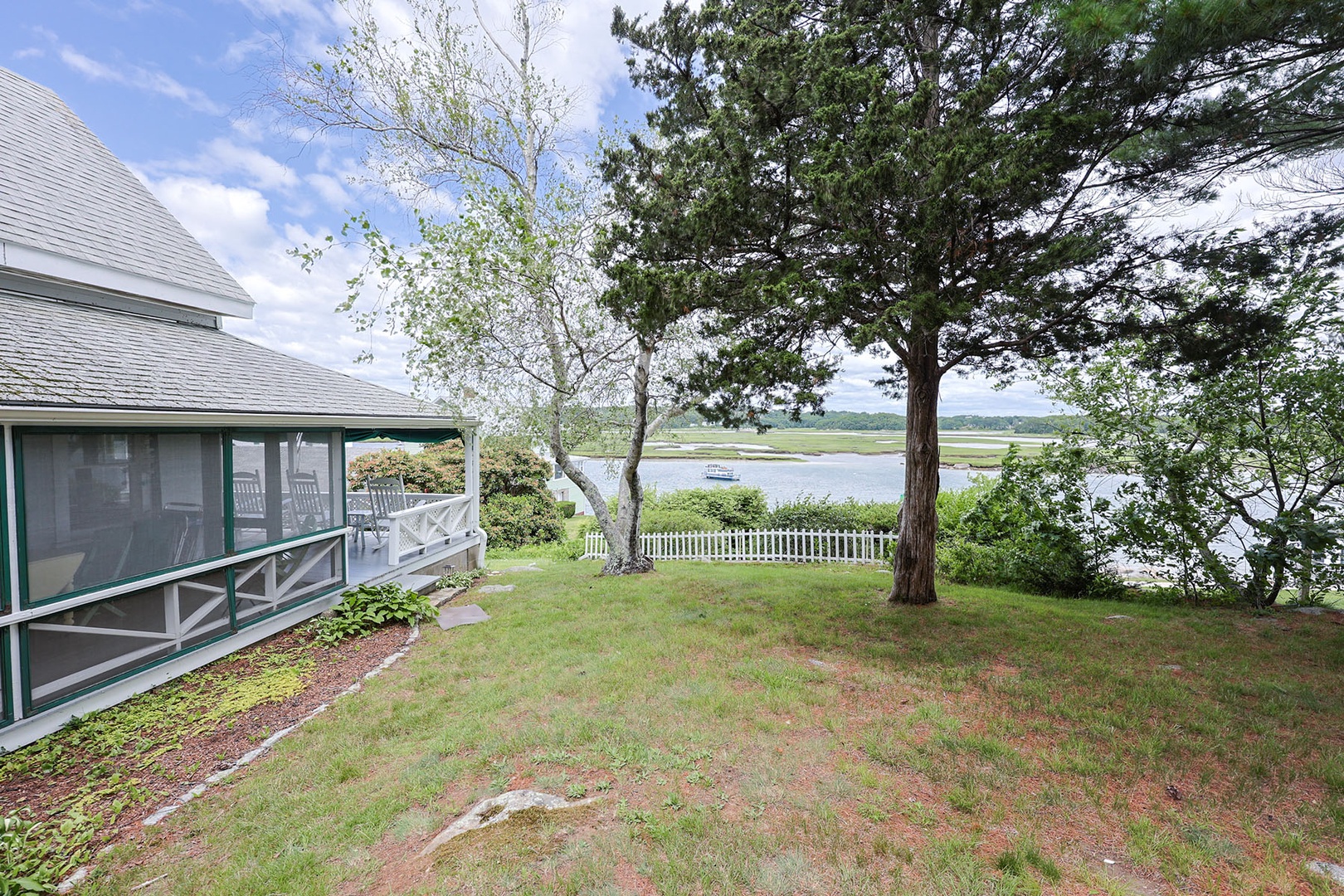 View from the garden, deck with rocking chairs on the left.