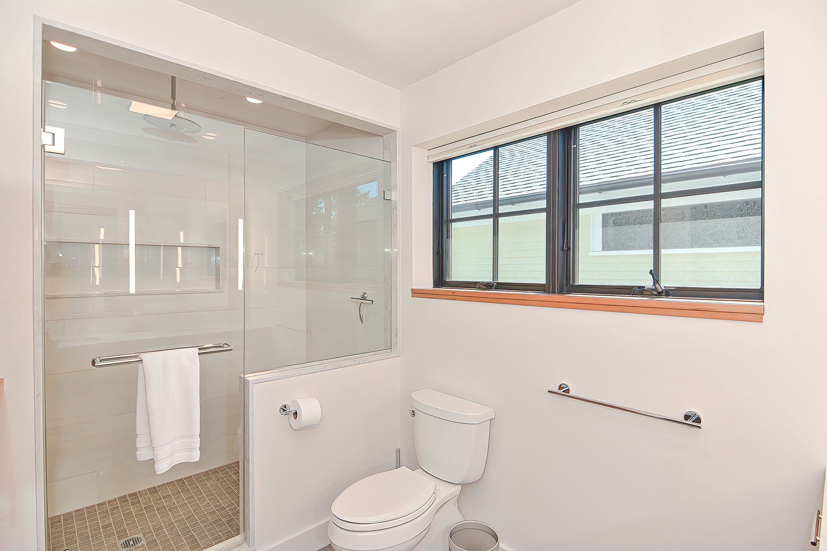 The full bath has a gorgeous tiled walk-in shower with a rain shower head.