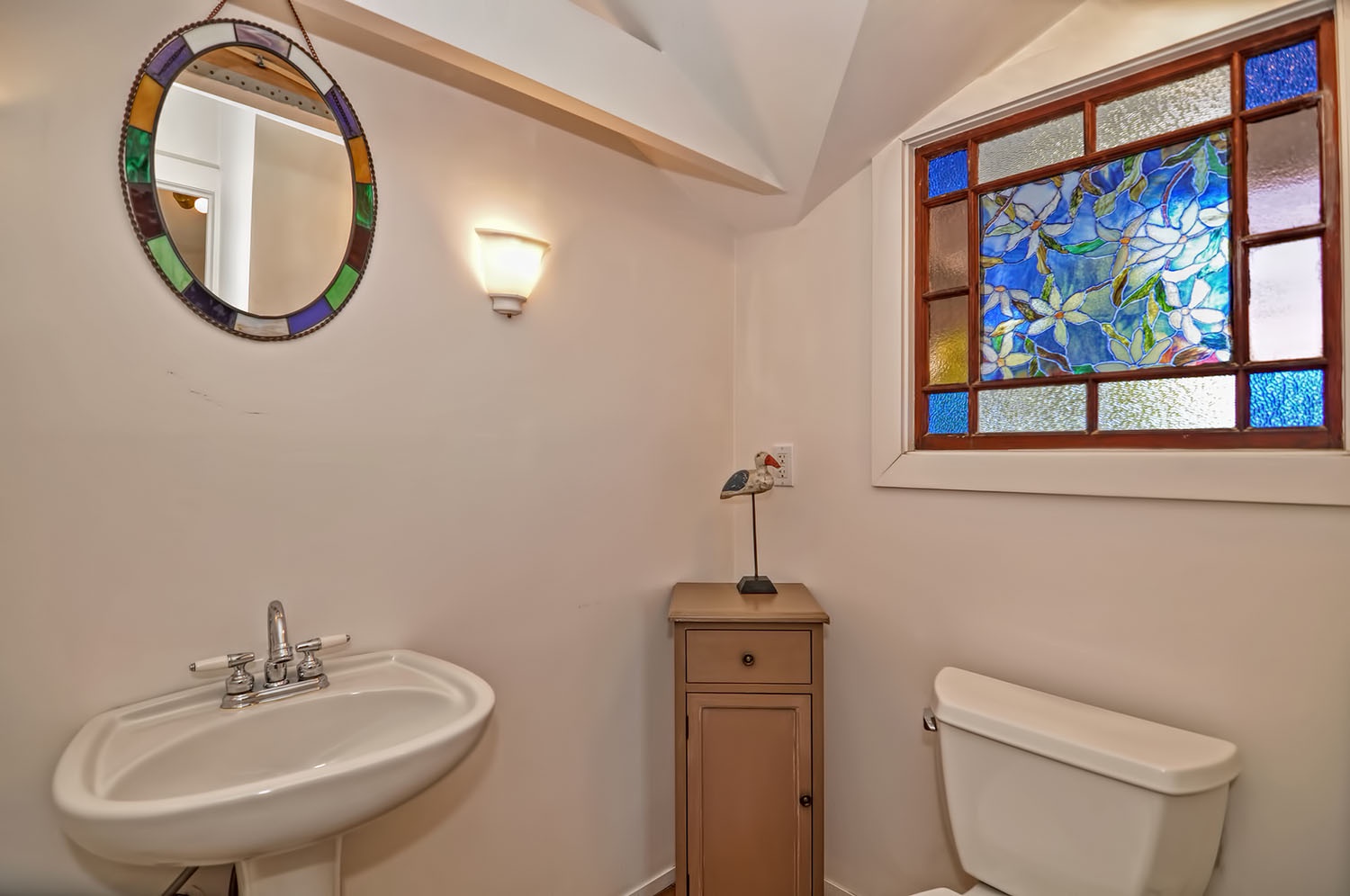 Main floor half bath with a stained glass window.